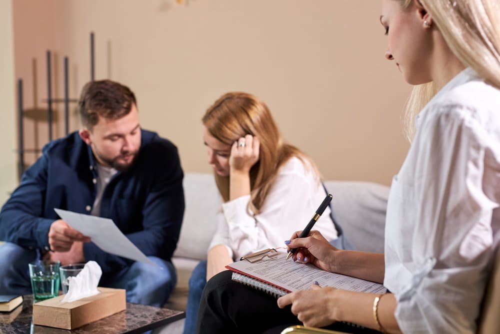 A mediator working with a couple during a family dispute resolution session